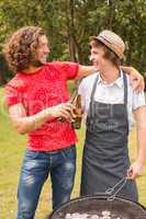 Happy friends in the park having barbecue