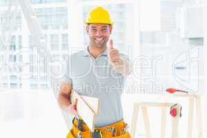 Carpenter gesturing thumbs up at construction site