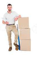 Confident delivery man with cardboard boxes