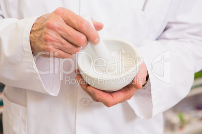 Close up of pharmacist mixing medicine