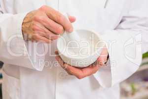 Close up of pharmacist mixing medicine