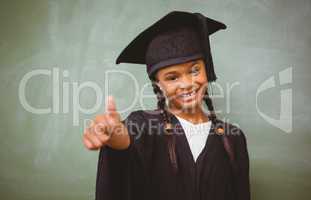 Girl in graduation robe gesturing thumbs up