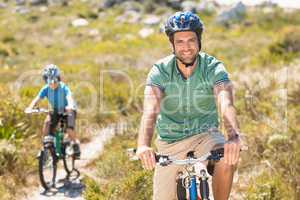 Father and son biking through mountains