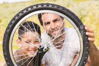 Father and son repairing bike together