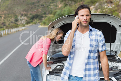 Young couple after a car breakdown