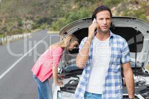 Young couple after a car breakdown