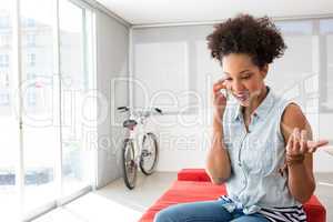 Young casual woman using cellphone