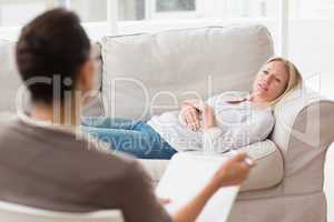 Psychologist talking to depressed female patient