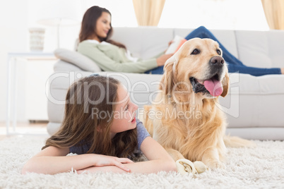 Girl with dog on rug at home