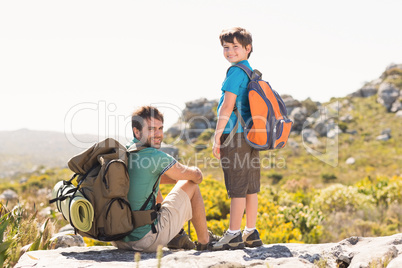 Father and son hiking through mountains