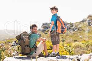 Father and son hiking through mountains