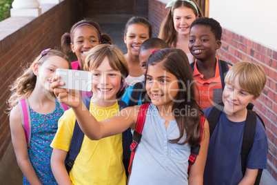 Cute pupils using mobile phone