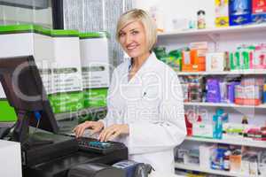 Smiling pharmacist using computer