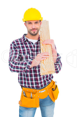 Handyman holding wood planks