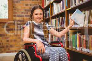 Girl in wheelchair selecting book in library