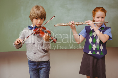 Students playing flute and violin in classroom