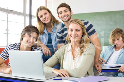 Students using laptop in classroom