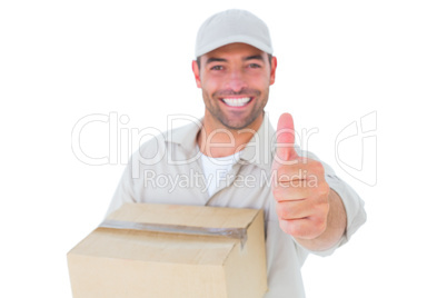 Delivery man with cardboard box gesturing thumbs up
