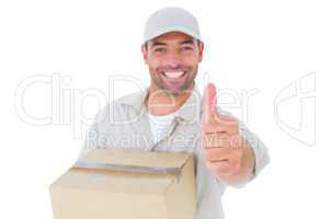 Delivery man with cardboard box gesturing thumbs up