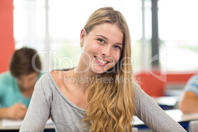 Smiling female student in classroom