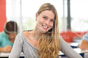 Smiling female student in classroom