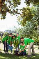 Environmental activists planting a tree in the park