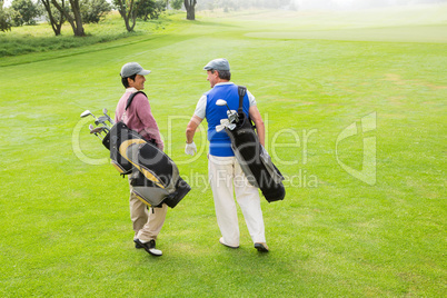 Golfer friends walking and chatting