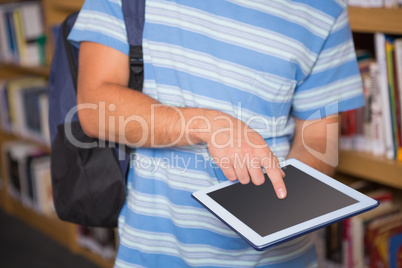 Student using tablet in library