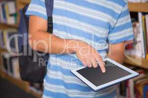 Student using tablet in library