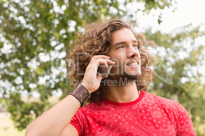 Happy young man using smartphone