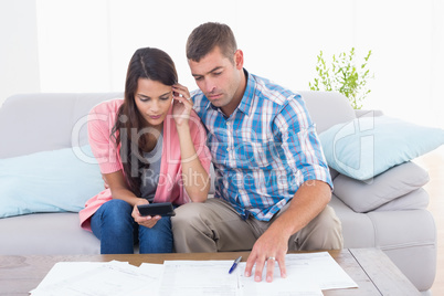 Couple calculating home finances at table