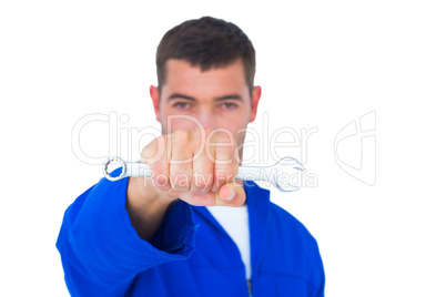 Confident male mechanic holding spanner