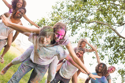 Happy friends covered in powder paint