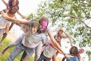 Happy friends covered in powder paint