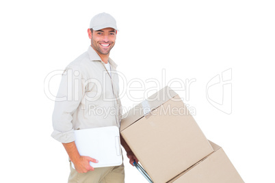 Delivery man pushing trolley of boxes on white background