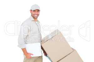 Delivery man pushing trolley of boxes on white background