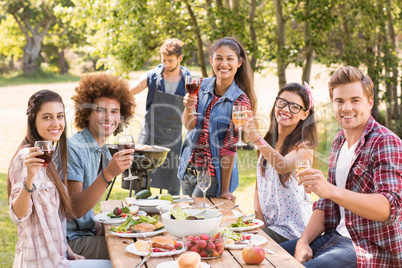 Happy friends in the park having lunch