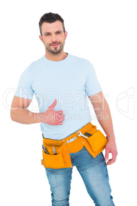 Handyman wearing tool belt with thumbs up