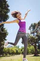 Fit woman leaping in the park