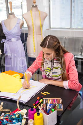 Fashion designer sketching dress