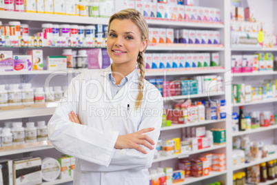 Portrait of a smiling student in lab coat with arms crossed