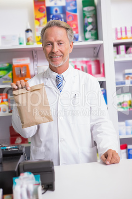 Senior pharmacist showing a envelope