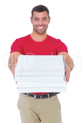 Happy delivery man giving pizza boxes