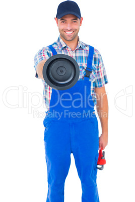 Handyman holding plunger and wrench on white background