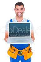 Portrait of smiling repairman showing laptop