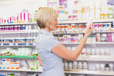 Pretty blonde customer looking at medicine