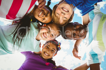 Portrait of happy children forming huddle