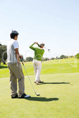 Golfing friends teeing off