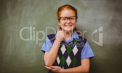 Portrait of cute little girl gesturing thumbs up