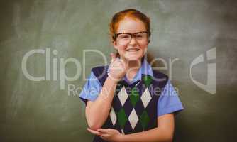 Portrait of cute little girl gesturing thumbs up
